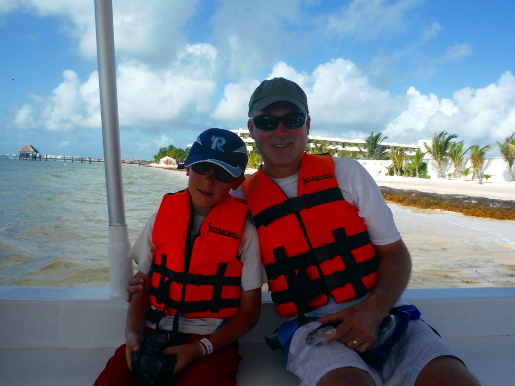 Dad and me on the boat to go snorkeling
