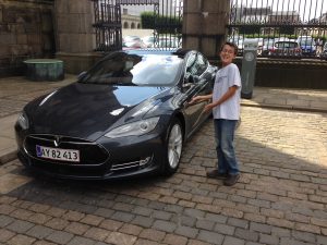Me by a Tesla at the Palace